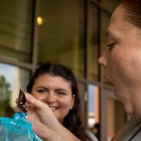 Students admiring items during Student Small Business Market.